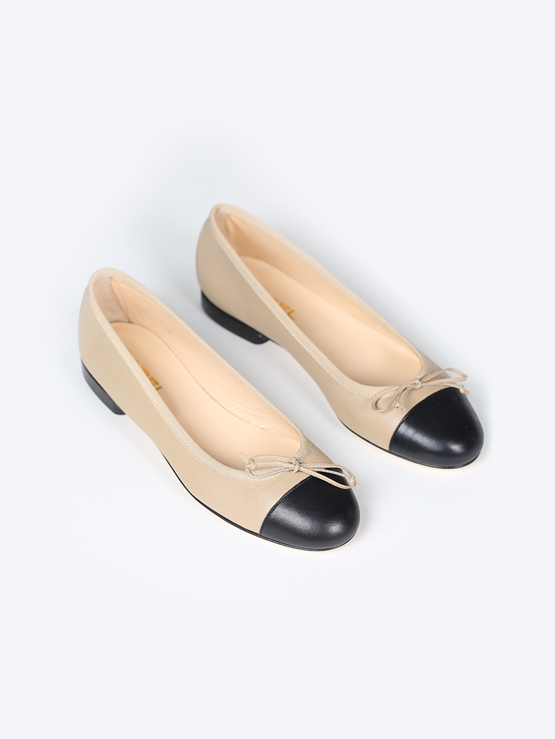 Black and beige leather ballet flats